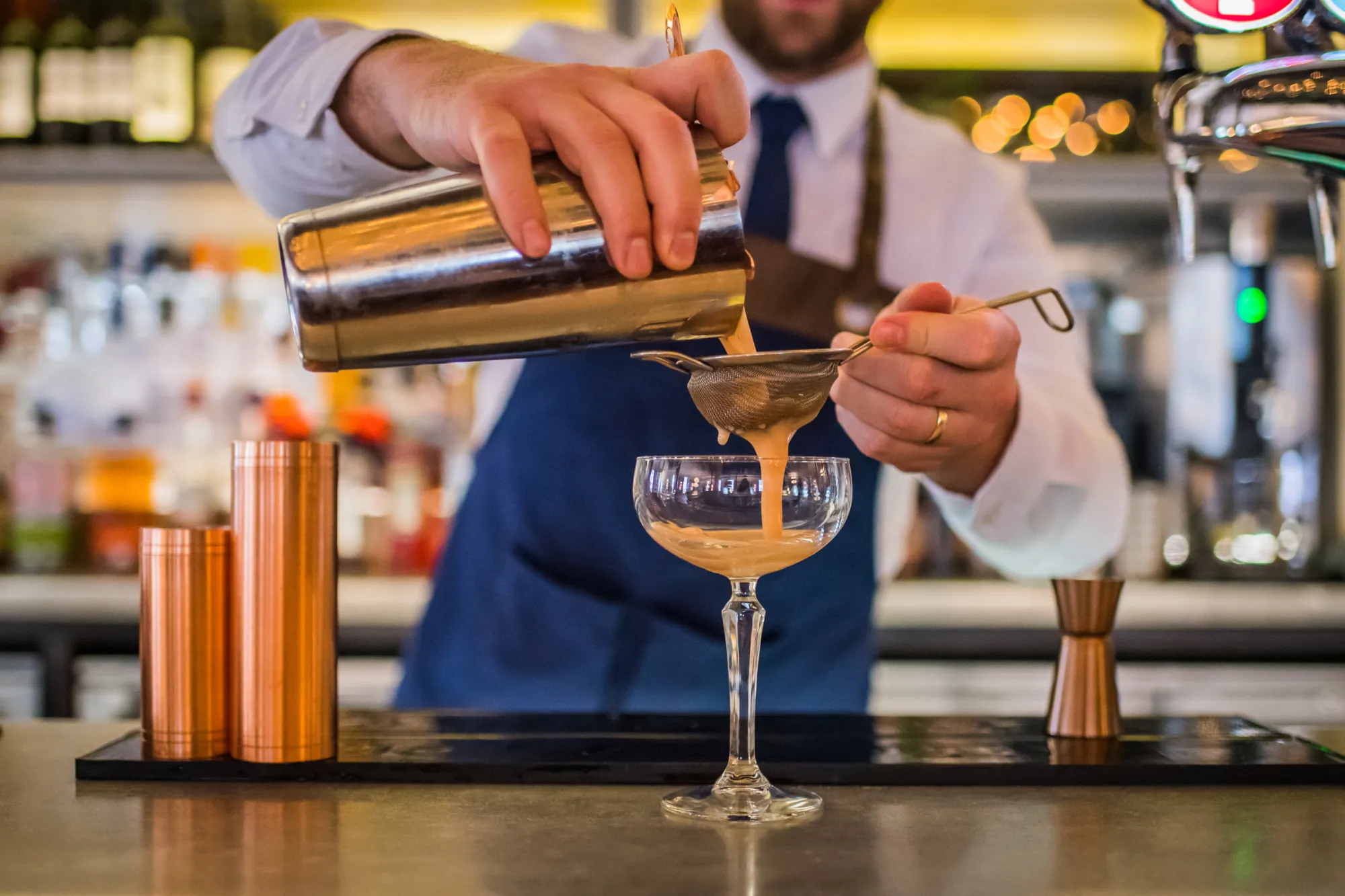 Waiter pouring cocktail